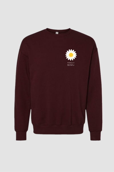 Maroon sweatshirt with a white daisy graphic and text pursuit ikigai