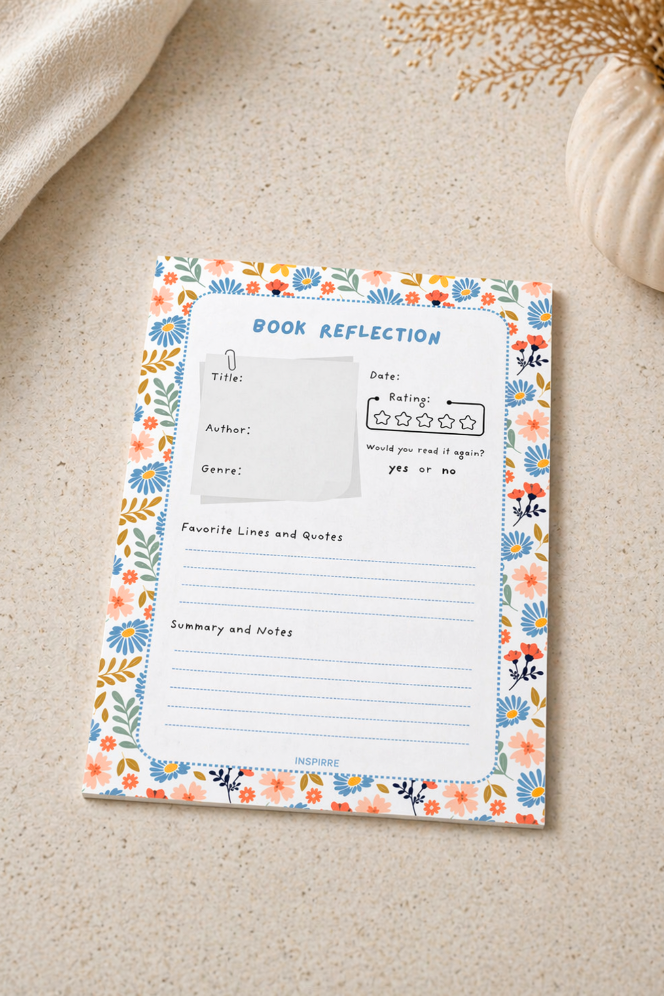 Floral notebook with 'Book Reflection' page on a beige surface