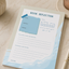 Notebook titled 'Book Reflection' on a light surface with a plant and candle in the background