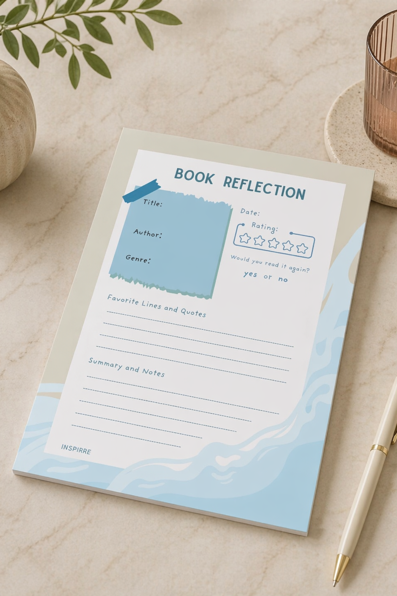 Notebook titled 'Book Reflection' on a light surface with a plant and candle in the background