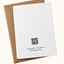 A white greeting card with a black QR code and 'Handmade in New Jersey' text, shown with a brown kraft envelope on a light cream background.