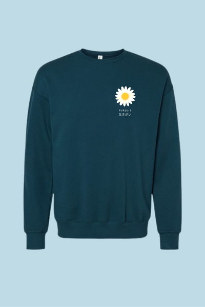 teal sweatshirt with a white daisy graphic and text pursuit ikigai